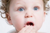 Child holding mouth at Pediatric Dentist Office in Clarks Summit